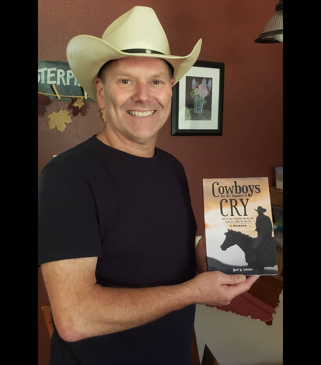 Shows me, the author, holding the first physical copy of my upcoming memoir - Cowboys Are Not Supposed to Cry